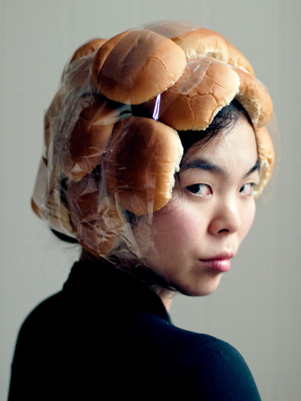 portrait of a woman with buns taped to her head