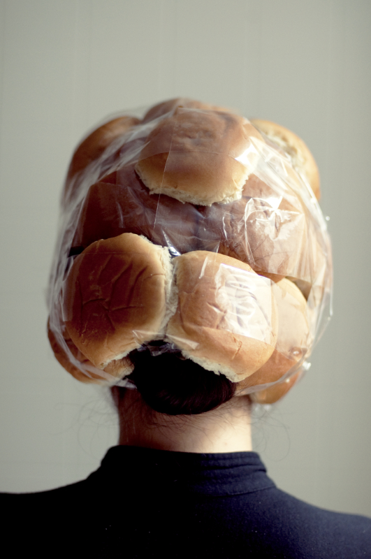 portrait of a woman with buns taped to her head