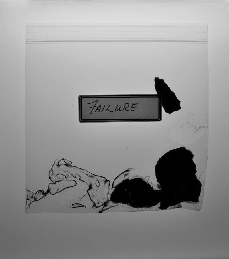 black and white close up of decomposing tangerine peel in a ziplock bag with a label that reads 'failure'